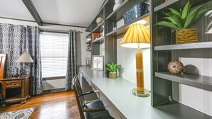 A modern living room with a wooden floor, a sofa, a coffee table, a lamp, and a bookshelf. - Pets Welcome! Comfortable and Spacious! Sleeps 6 (Frankston)
