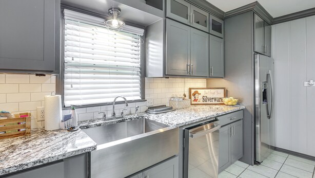 A kitchen with a stainless steel sink, a built-in dishwasher, and a refrigerator. - Pets Welcome! Comfortable and Spacious! Sleeps 6 (Frankston)