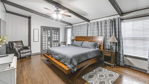 A bedroom with a bed, a chair, a nightstand, a lamp, a ceiling fan, and a window with blinds. - Pets Welcome! Comfortable and Spacious! Sleeps 6 (Frankston)