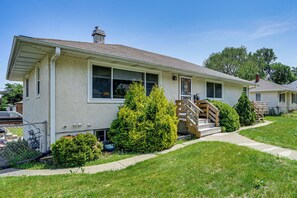 A single-story house with a front porch, a small front yard, and a visible garage. - Deck & Shared Yard! Relaxing South Saint Paul Home (South St. Paul)