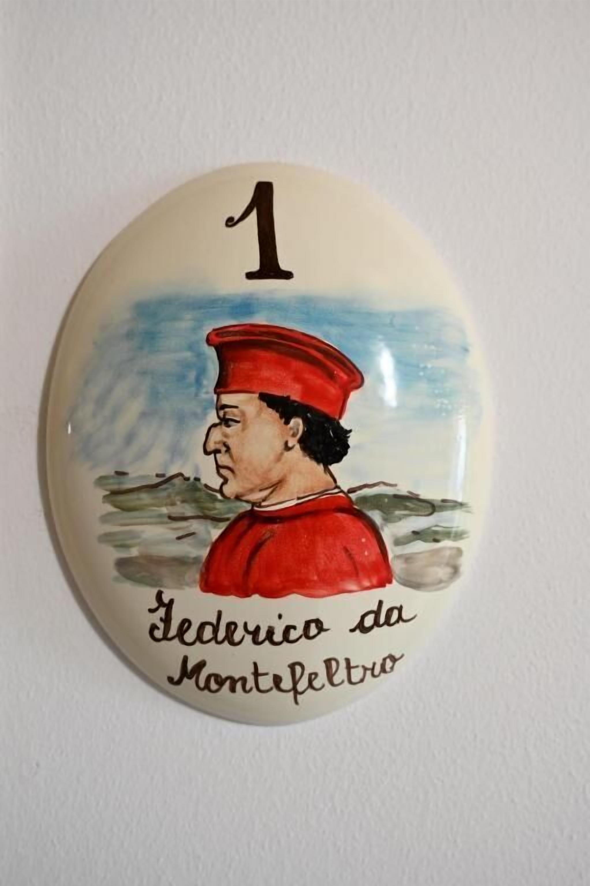 A ceramic plaque with a number '1' and the name 'Jederico da Montefeltro' on it.