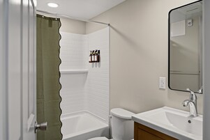 Un baño con ducha, inodoro y lavamanos.