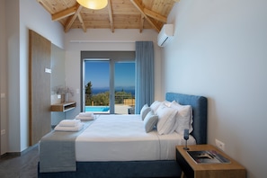 A bedroom with a large bed, a nightstand, a window with a view, and a wooden ceiling. - Ionian Harmony Villa 4 | Private Pool & Sea View (Tsoukalades)