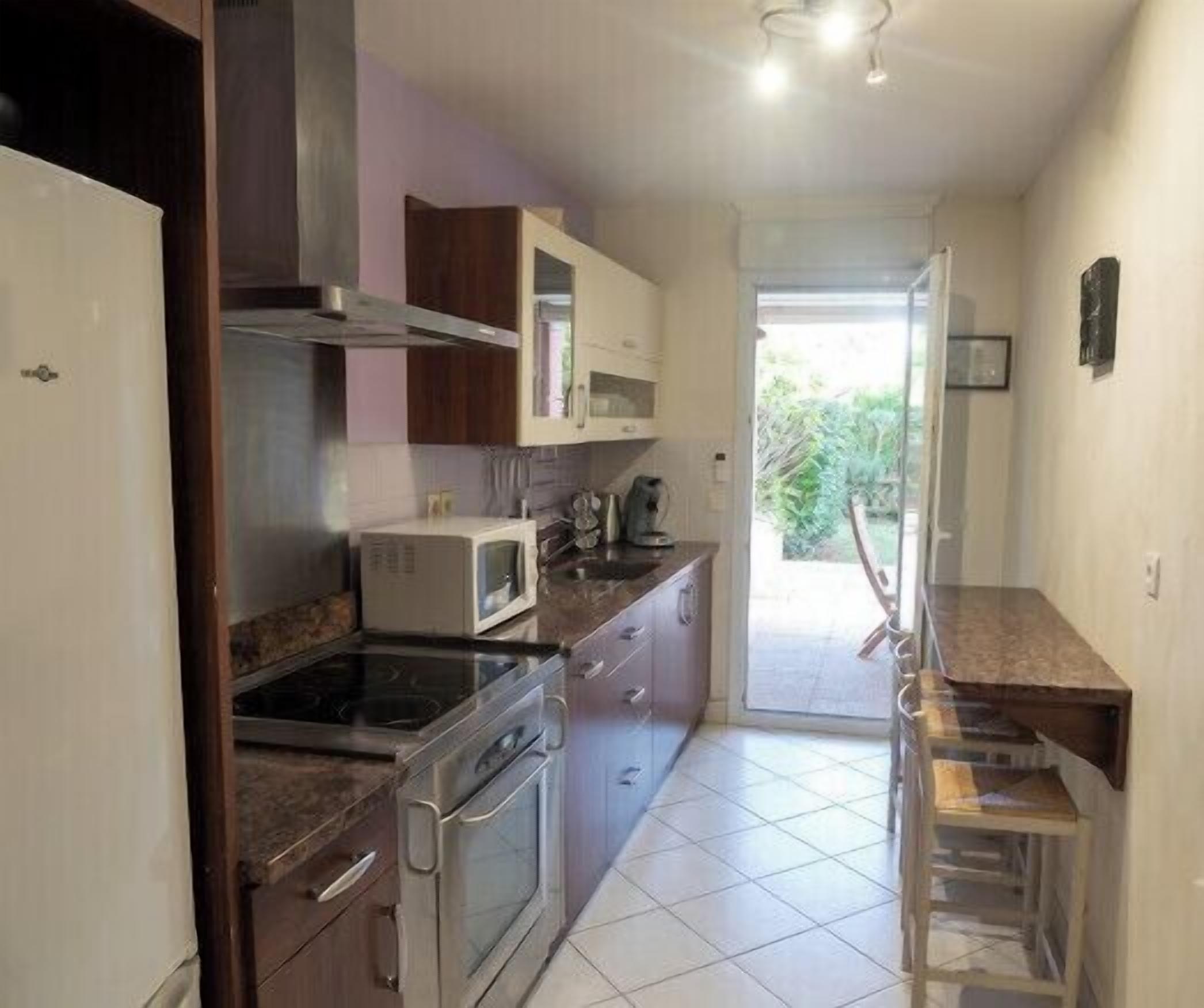 A kitchen with a stove, microwave, and cabinets.