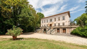 Un grande edificio storico con facciata simmetrica, numerose finestre e un ingresso centrale.