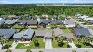 A residential neighborhood with houses, lawns, and a playground. - 4BR Foley Home Near OWA and Beaches (Foley)