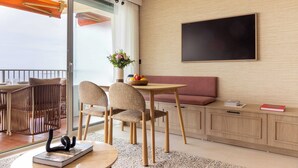A modern room with a dining area, a sofa, and a large window. - 1bdr/4p Flat With Stunning sea Views (Antibes)