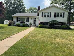 A two-story house with a front porch, a small garage, and a well-maintained lawn. - Spacious 4-bedroom house with AC in wonderful Williamsport (Williamsport)