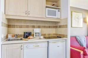 A compact kitchen with a microwave, coffee maker, and dishwasher. - Family Apartment for 4 in Ardeche (Grospierres)
