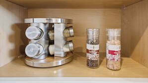 Eine Küche mit integriertem Kaffeeautomaten und zwei Gewürzbehältern.