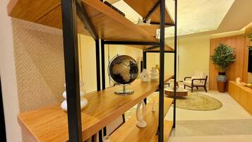 A modern interior with a wooden staircase, a globe, and a plant.