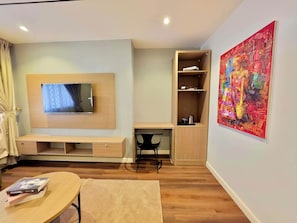 Suite, Courtyard View | Living area | 55-inch Smart TV with satellite channels, Netflix, Hulu - Amazonia Luxury  (Abuja)