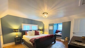 A bedroom with a bed, bedside tables, a nightstand, a desk, and a chair. - Beautiful 4-bedroom historic home on 4-acre lot in Niles, close to Hwy 12 (Niles)