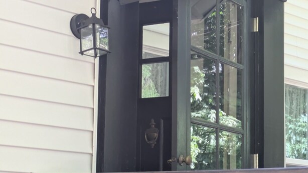 A black-framed entrance with a sign reading 'The Inn at Rivendell' and a wooden deck in front. - Beautiful 4-bedroom historic home on 4-acre lot in Niles, close to Hwy 12 (Niles)