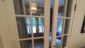 A room with a large window, a chandelier, and a bed. - Beautiful 4-bedroom historic home on 4-acre lot in Niles, close to Hwy 12 (Niles)