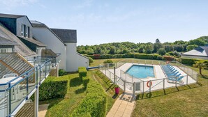 A residential property with a swimming pool, a covered outdoor area, and a view of a forested hill. - Stunning Oceanfront Haven for 2 (Île-aux-Moines)