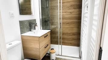 Shower, hair dryer, towels, toilet paper