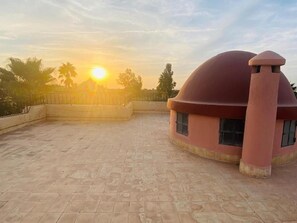 Un bâtiment doté d’un toit en forme de dôme et d’une terrasse plane.