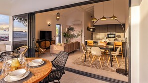 A modern interior with a dining area, kitchen, and living space. - Curadise Penthouse - luxury poolside apartment in Jan Thiel (Jan Thiel)