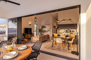 A modern interior with a dining area, kitchen, and living space. - Curadise Penthouse - luxury poolside apartment in Jan Thiel (Jan Thiel)