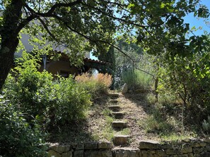 A stone staircase leading up a hill, surrounded by greenery and a building in the background. - Bioclimatic villa with natural garden at the end of a cul-de-sac, quiet neighborhood. (Montauroux)