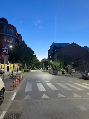 A street view with a pedestrian crossing, traffic cones, and buildings. - Your Cozy Home in Skopje (Skopje)