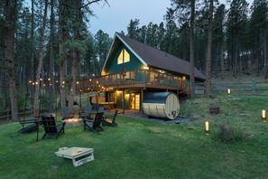 A lodge with a deck, outdoor seating, and a fire pit. - Black Hills Retreat Sauna/Hot Tub 5 min to Pactola (Rapid City)