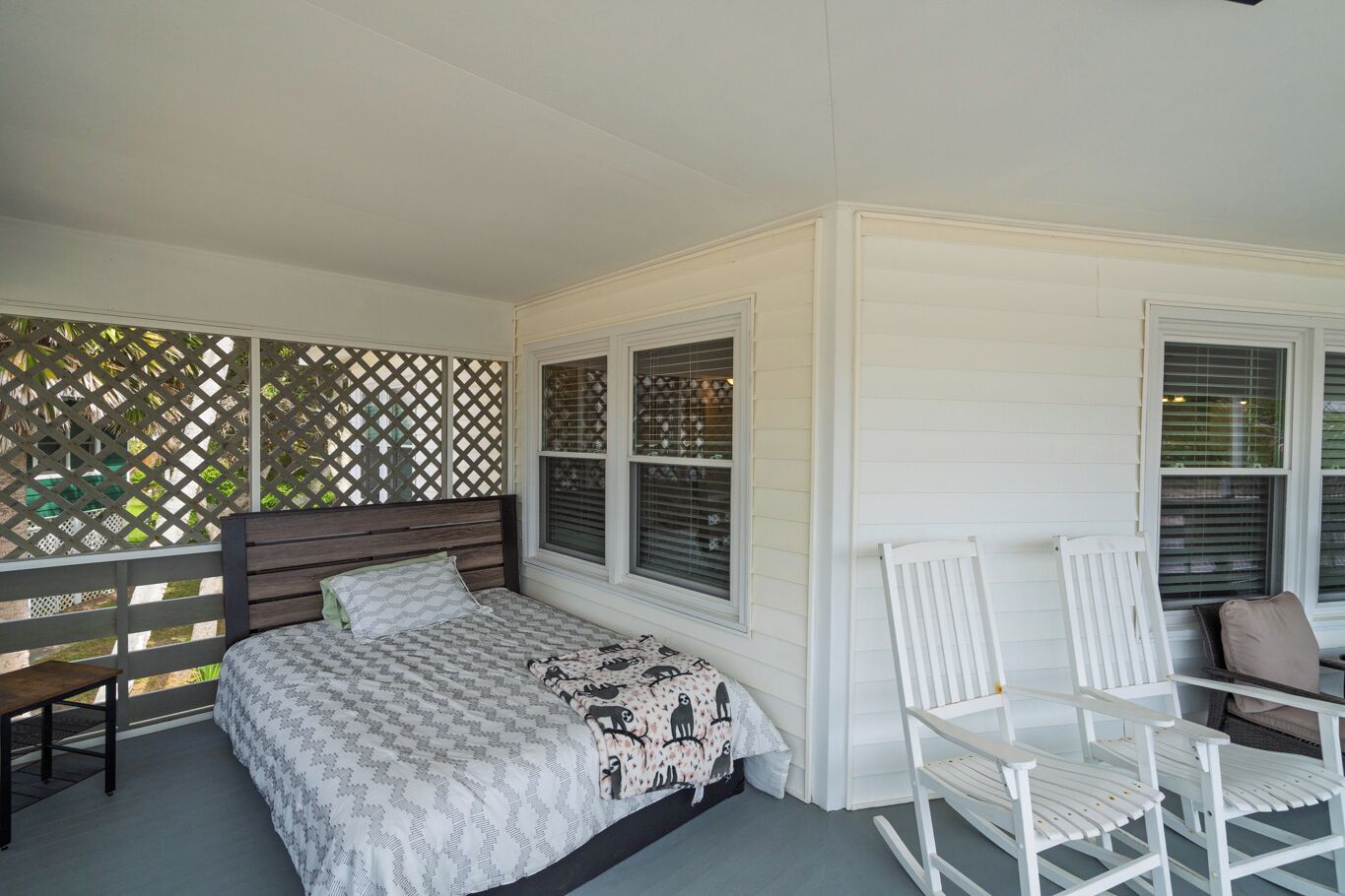 A bedroom with a bed, a bench, and a chair.