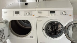 Two white Miele Professional PT 9136 washing machines side by side. - Cozy bright 1 room apartment in Bramsche max. 3 persons (Bramsche)