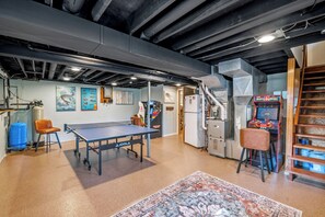 A spacious room with a ping pong table, a small bar area, and a retro arcade machine. - Waterfront Vacation with optional pontoon rental.  Relax in the great up north! (Pound)