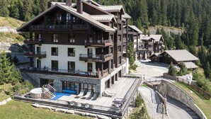 A multi-story chalet with balconies, a swimming pool, and a ski lift. - Mountain Side Stay With Sauna (Araches-la-Frasse)