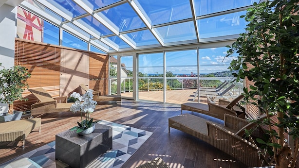 A spacious indoor area with a high ceiling, large windows, and outdoor views. - Premium Normandy Apartment for 4 (Houlgate)