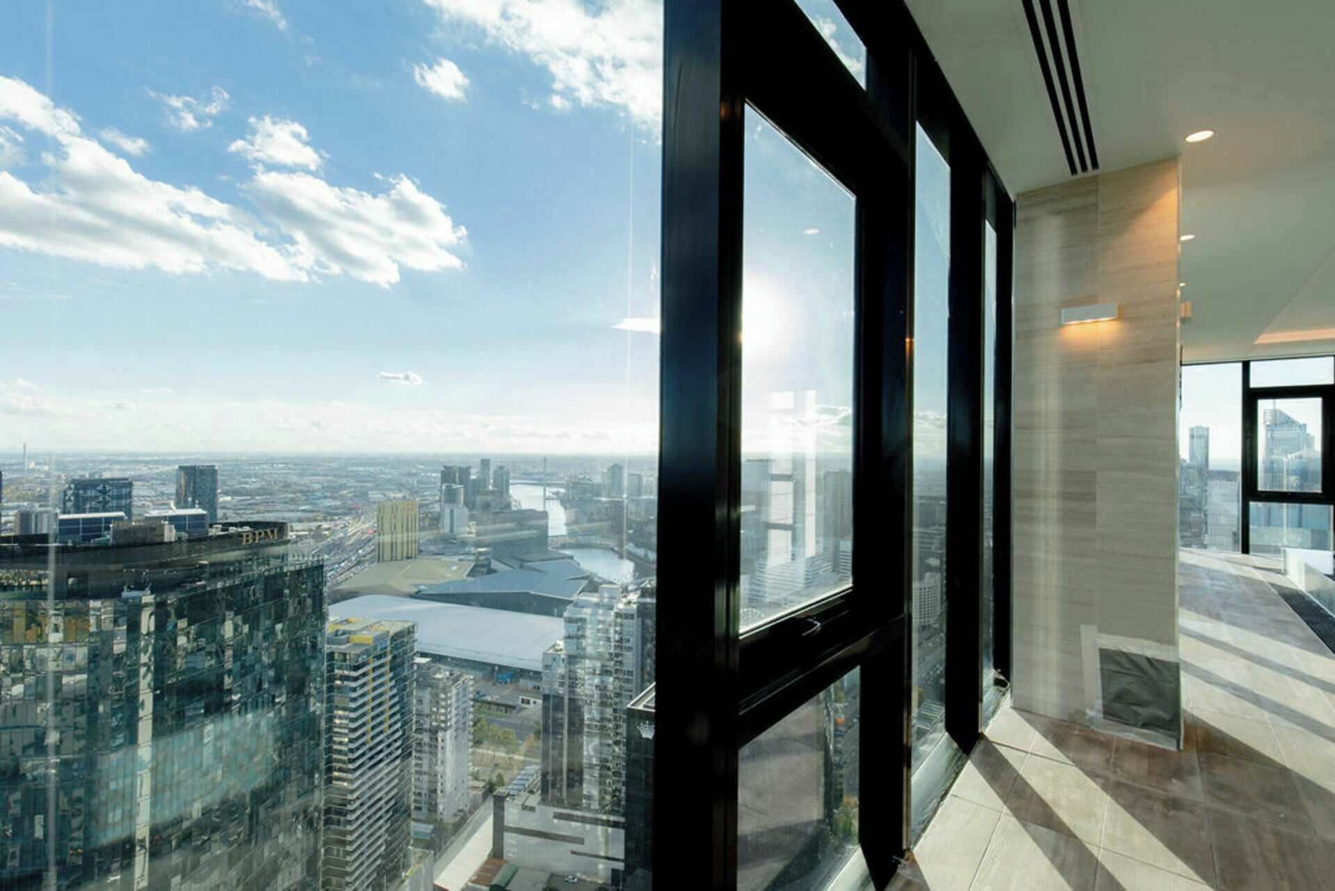 A high-rise building with large windows offering a city view.