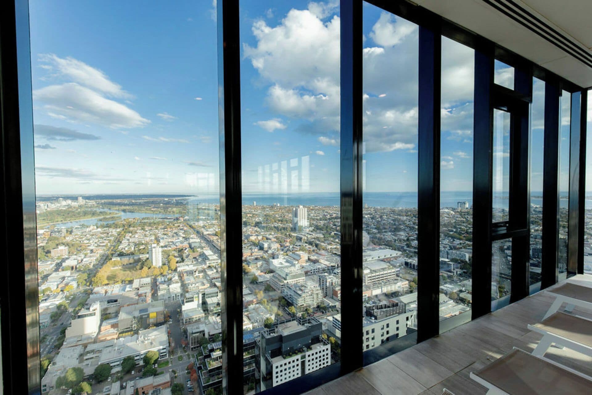 A high-rise building with large windows offering a panoramic city view.