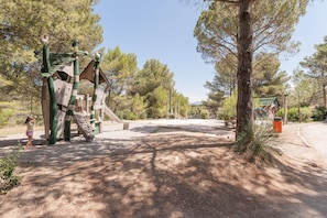 A playground with climbing structures and a dirt path. - Stay With Private Outdoor Space (Mallemort)