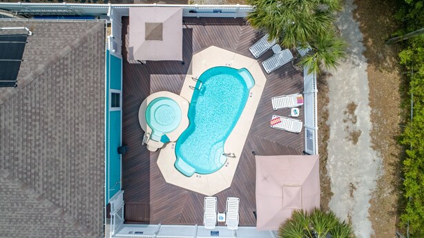 An aerial view of a rooftop pool area with a hot tub, lounge chairs, and a deck. - Sunrise Retreat Private Pool & Hot Tub. Golfers Delight. Steps to the beach. (North Myrtle Beach)