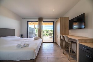 A hotel room with a bed, a desk, a chair, a TV, and a balcony with a view. - Southern Corsica Retreat With Pool (Lecci)