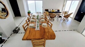 A dining area with a wooden table set for six, surrounded by wooden chairs. - Family House in Huatulco, 4 Bedrooms, pool, A.A. Wi Fi, centrally located parking (bahias de huatulco)