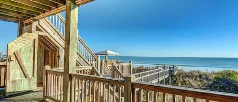 A wooden deck with a view of the ocean.