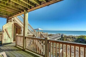 A wooden deck with a view of the ocean.