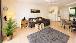 A modern living room with a sofa, coffee table, and a large rug. - Apartment by Playa Serena & Golf Views (Roquetas de Mar)
