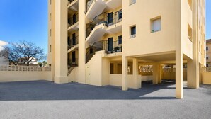A multi-story building with balconies, a central staircase, and a covered outdoor area. - Apartment by Playa Serena & Golf Views (Roquetas de Mar)