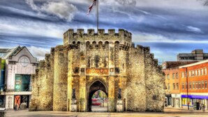 A historic stone castle gate with a flag, surrounded by modern buildings. - Southampton - House - Sleeps 6 - Near Airport (Southampton)