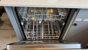 An open dishwasher with a control panel and a label indicating "TUN OPENER" and "CUTLER". - Southampton - House - Sleeps 6 - Near Airport (Southampton)