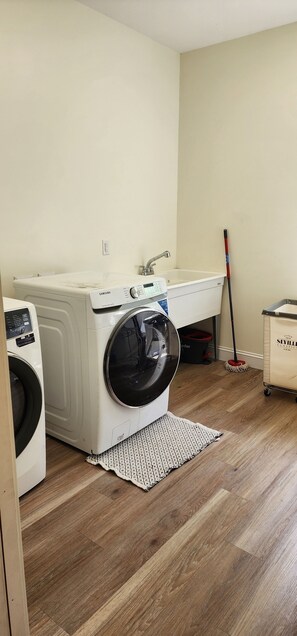 A laundry area with a washing machine, a dryer, a sink, and a mop. - Your retreat awaits! Plenty of space indoor and outdoor space. Pool, spa, OCT 26 (Fennville)