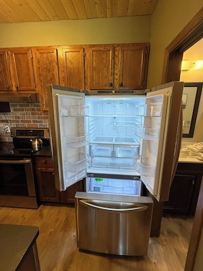 A stainless steel refrigerator with a freezer compartment, a built-in ice maker, and a water dispenser.