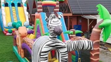 An inflatable playground with slides and climbing structures.