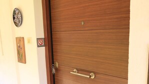 A closed wooden door with a handle and a keyhole. - Charming Glyfada Family Appartment close to the Beach & City center | Quiet Area (Glifada)