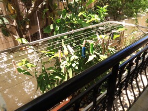 A metal railing with a view of a water feature and greenery. - Charming Glyfada Family Appartment close to the Beach & City center | Quiet Area (Glifada)