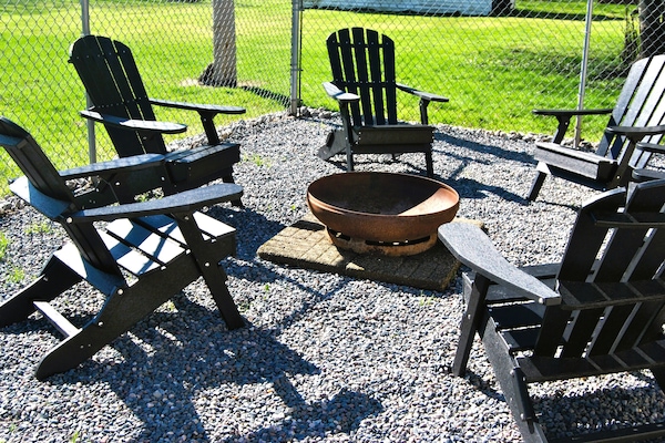 Outdoor backyard, Adirondack chairs, fire pit, gas grill, table & chairs.